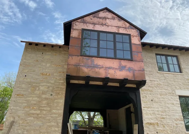 Copper metal panel facade on a stone building for Roof Repair in Tinley Park