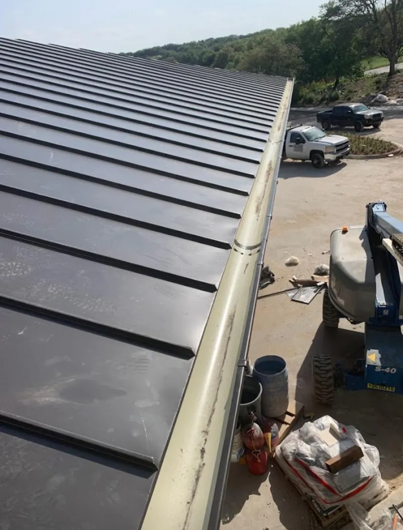 Standing seam panel and gutter detail on a metal roofing jobsite in Tinley Park